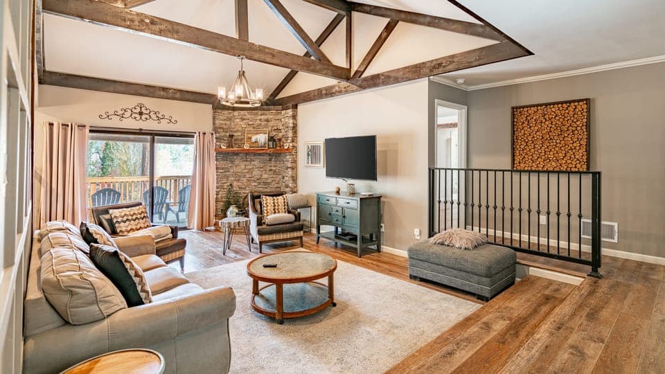 Bright living area with TV and deck access.