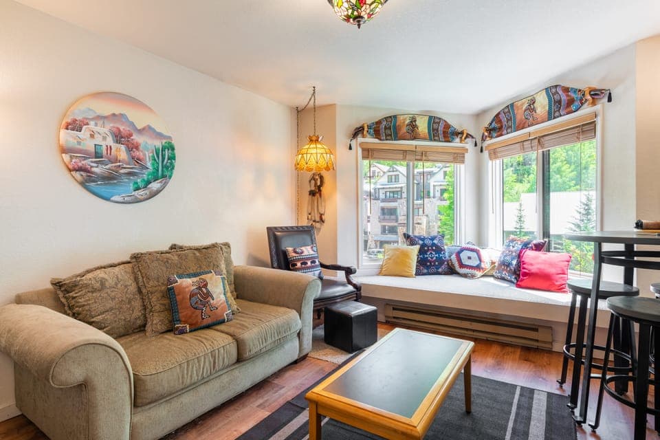 Bright and sunny living room with a bay window seat.