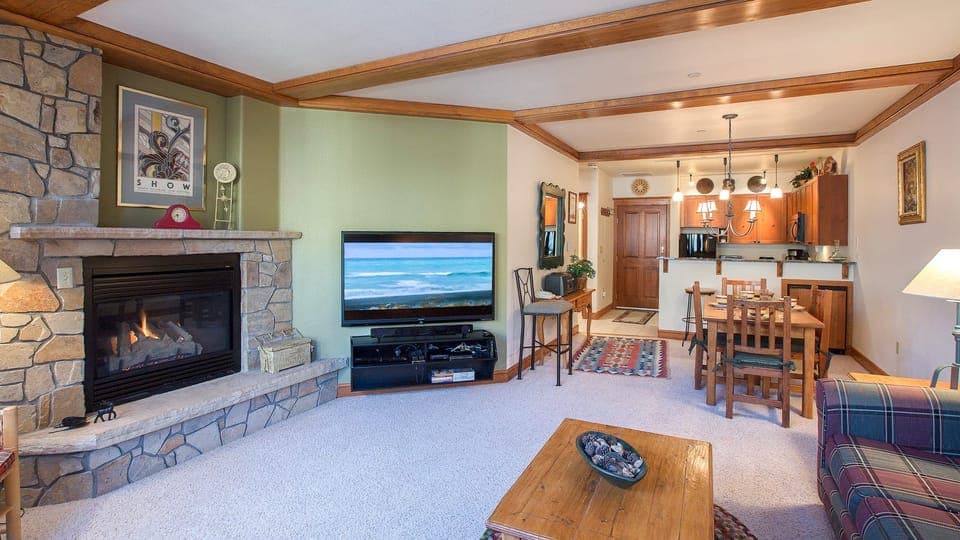 Cozy living room with a fireplace, comfortable seating and a TV to keep you entertained.