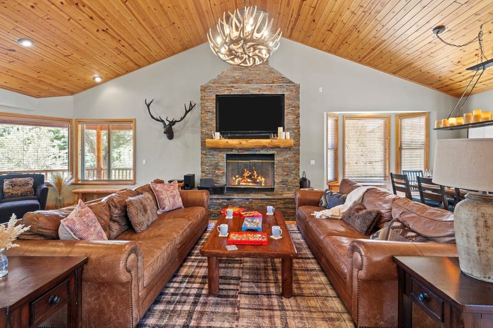 The living room features a large stone fireplace.