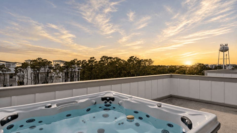 Soak in the rooftop hot tub with sweeping views—now elevated by soft sunset skies and a peaceful coastal horizon.