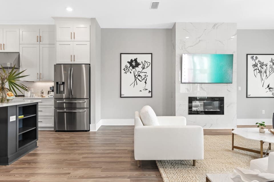 Bright open-concept living with sleek kitchen, modern fireplace, and effortless flow for gathering and relaxing.