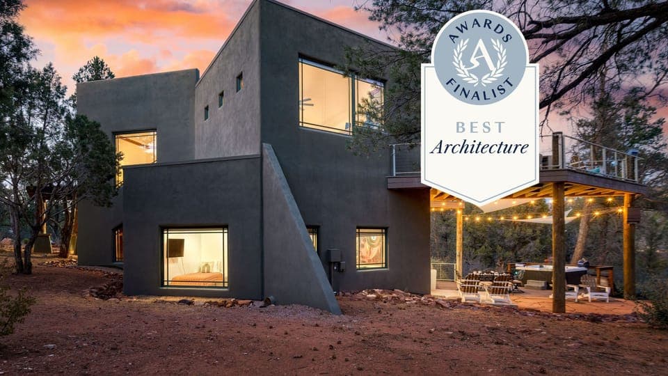 Entertainer's paradise with an outdoor dining table, hot tub, and evening lighting.