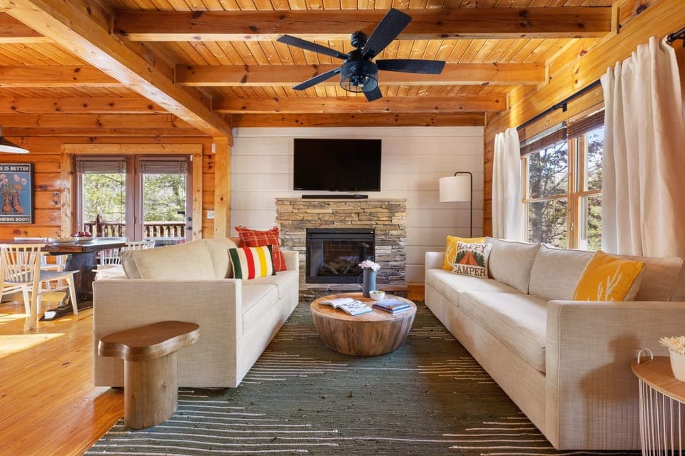 The living room features a fireplace and TV.