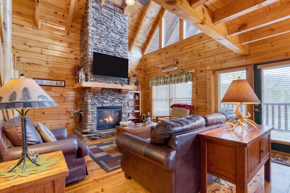 Cozy living room with plush seating and a warm fireplace.