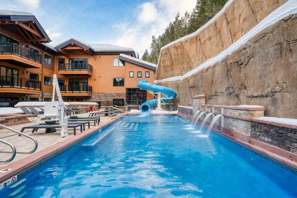 Outdoor oasis with a waterslide, plenty of loungers, and a spacious patio.