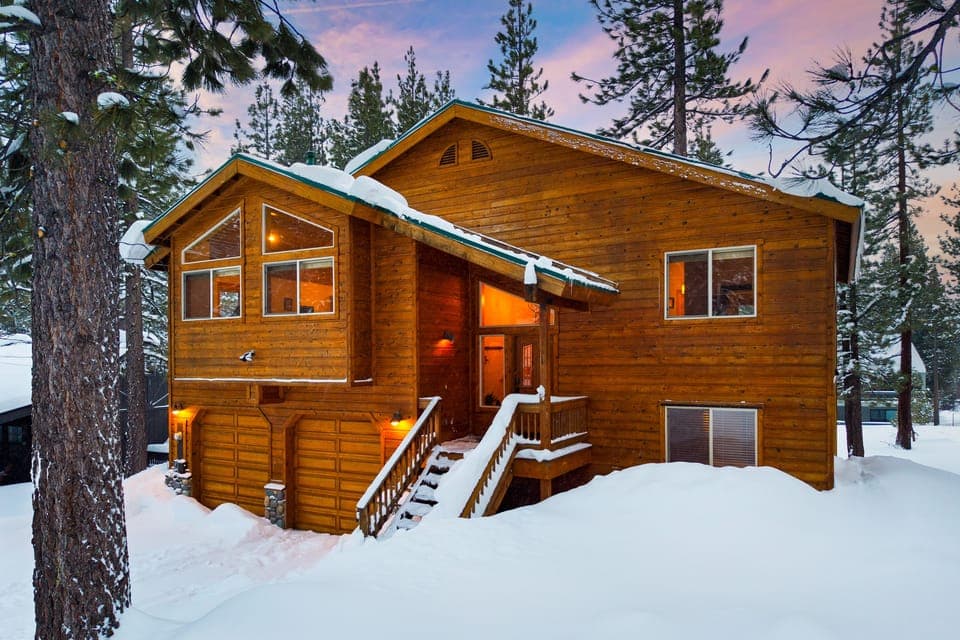 Wooden cabin surrounded by trees.