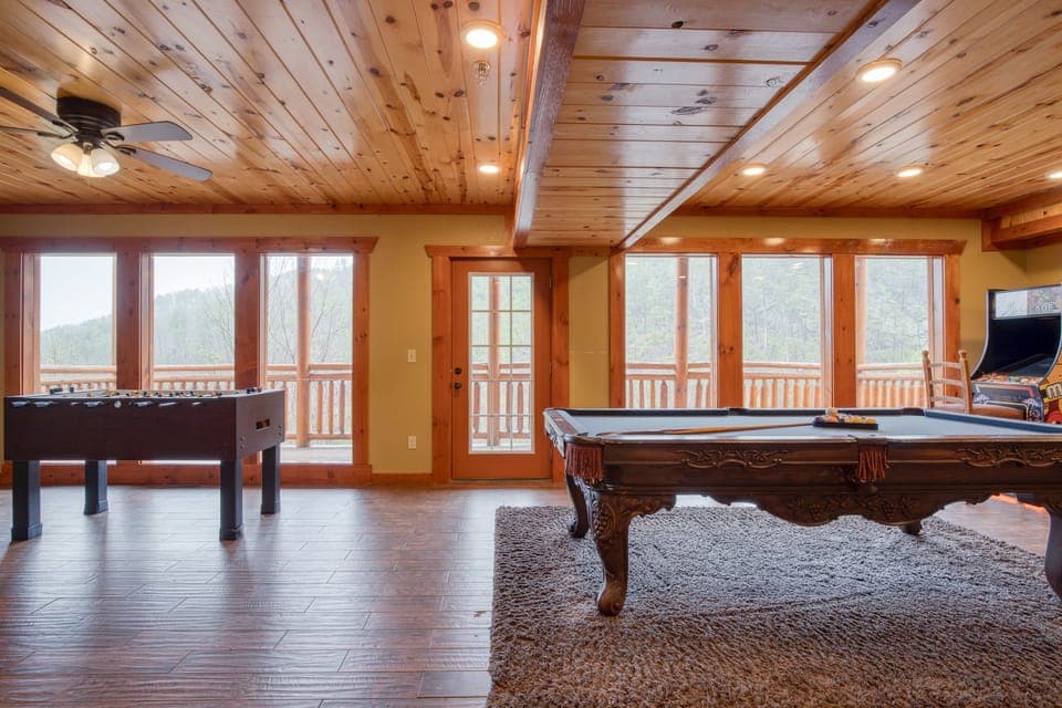 Game room features a pool table, foosball, and multi-game arcade.