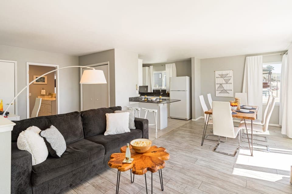 Bright and stylish living room with cozy seating and dining area.