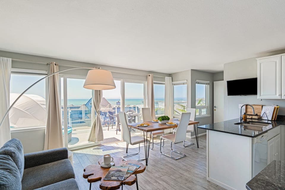 Spacious sunlit living and dining area with ocean views. (Cayucan Bungalow 225)