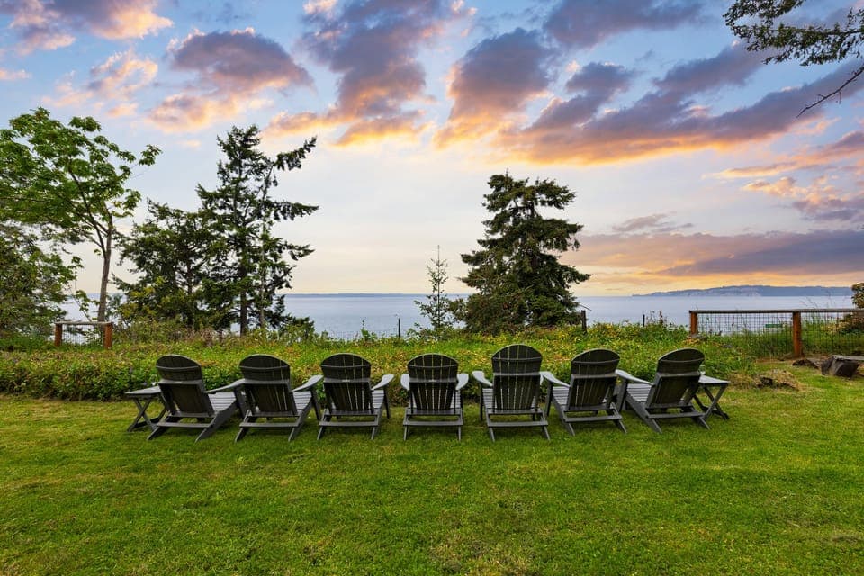 Peaceful outdoor setting with Adirondack chairs.