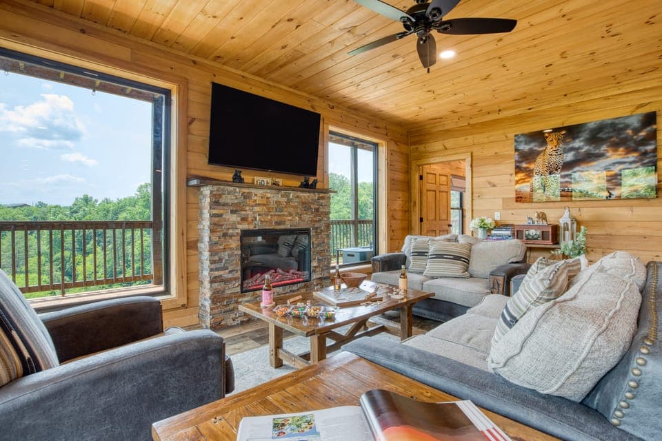 Living room with comfy seating, a warm fireplace, and a TV—perfect for relaxing after a day of adventure.