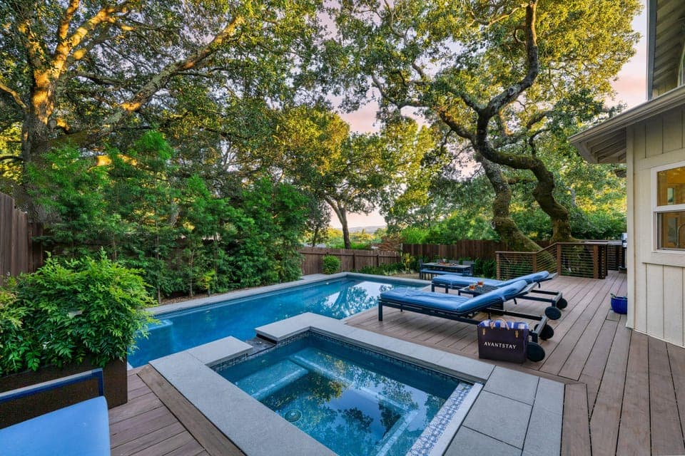 Relax and unwind in the serene pool and spa in the private backyard.