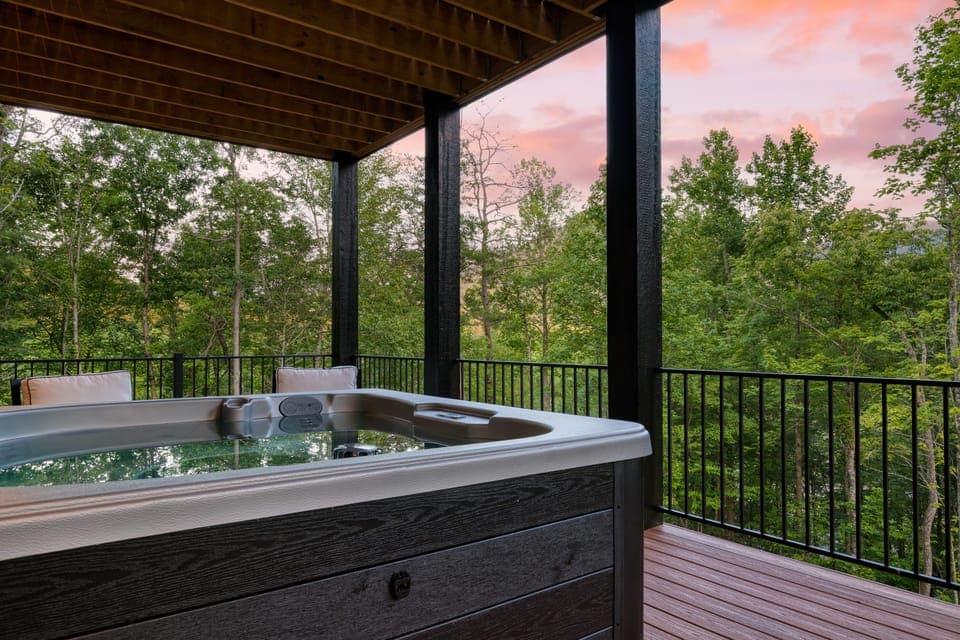 Covered hot tub with sunset mountain views.