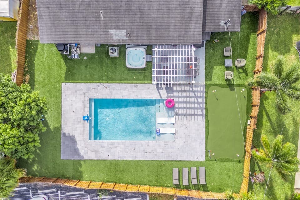 Aerial view of pool and backyard.