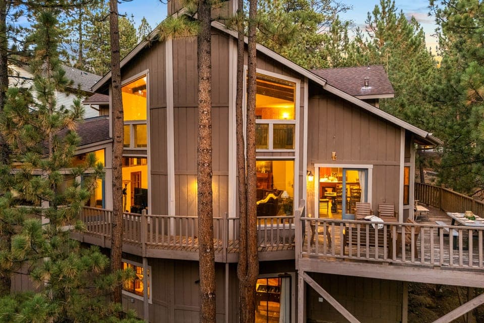 Tucked away in the pines, this cabin's warm glow and inviting decks are the perfect welcome to your getaway.
