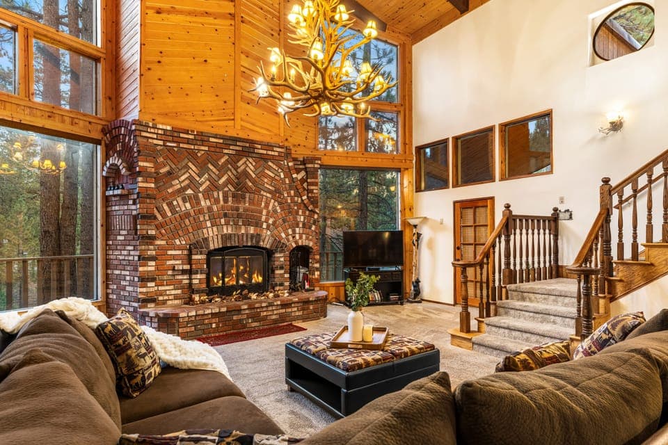 Soaring vaulted ceilings and a stunning floor-to-ceiling brick fireplace create a truly grand yet cozy space to relax with loved ones.