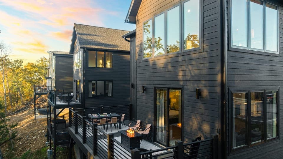 Where breathtaking views meet modern design. The home's exterior is wrapped in the golden glow of twilight.