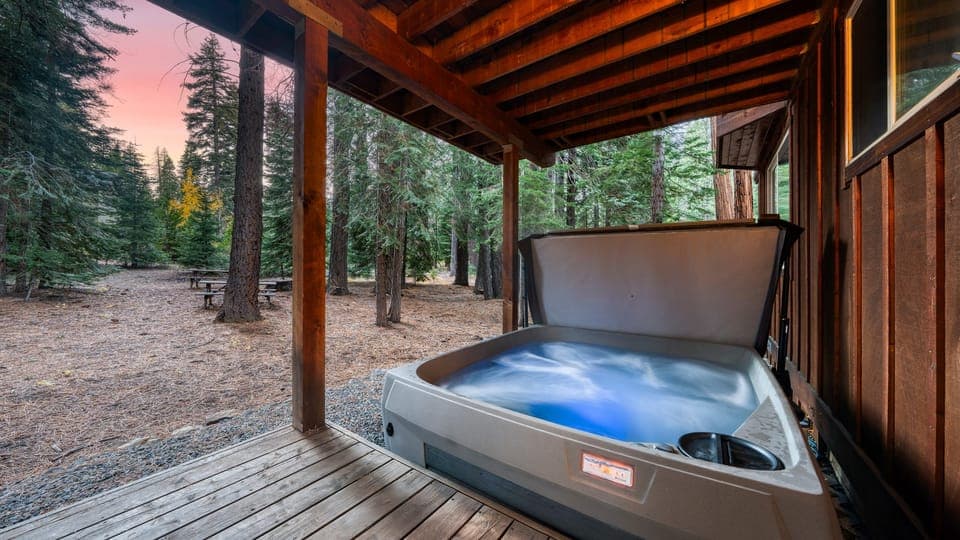 Outdoor hot tub under a covered deck.