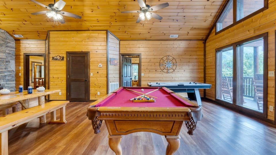 Game room with pool table, air hockey &amp; arcade games.