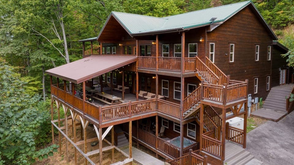 Your ultimate mountain escape awaits. This massive, multi-level cabin retreat offers endless decks, stunning views, and space for everyone to gather and relax.