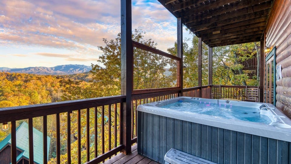 Soak in the private hot tub while taking in panoramic Smoky Mountain views from the covered deck.
