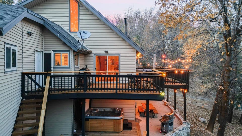Spacious forest-view deck with firepit and outdoor dining — your private mountain retreat among the trees.