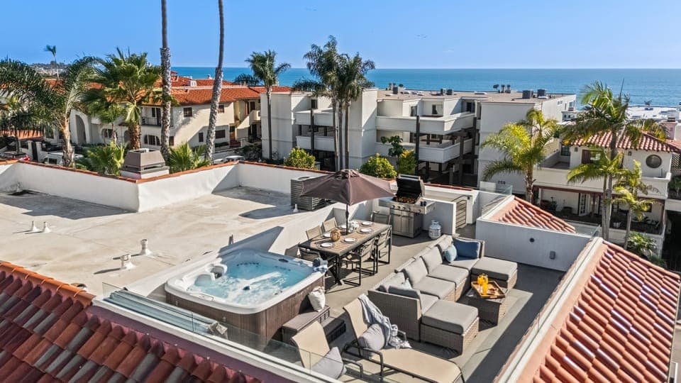Private rooftop deck with hot tub, ocean views, and coastal breezes — the ultimate Newport Beach escape. (Unit 1)