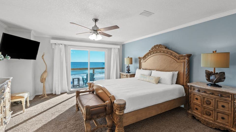 The primary bedroom features a king bed, TV, and an ensuite bathroom.
