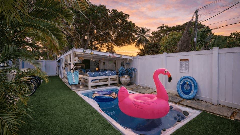 Private tropical backyard with a swim spa and shaded cabana—perfect for sunny days and laid-back evenings.