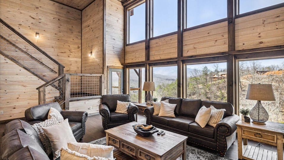 Leather seating surrounded by floor-to-ceiling windows.