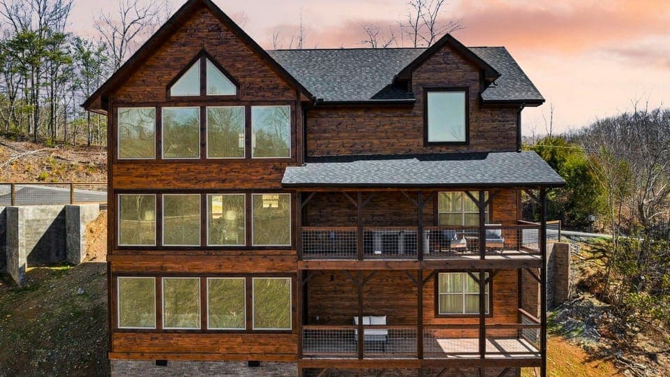 Stunning multi-level modern mountain cabin at sunset.