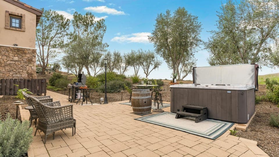 Private hot tub and open-air patio set against rolling vineyard views—perfect for unwinding after a day of wine tasting or outdoor adventures.