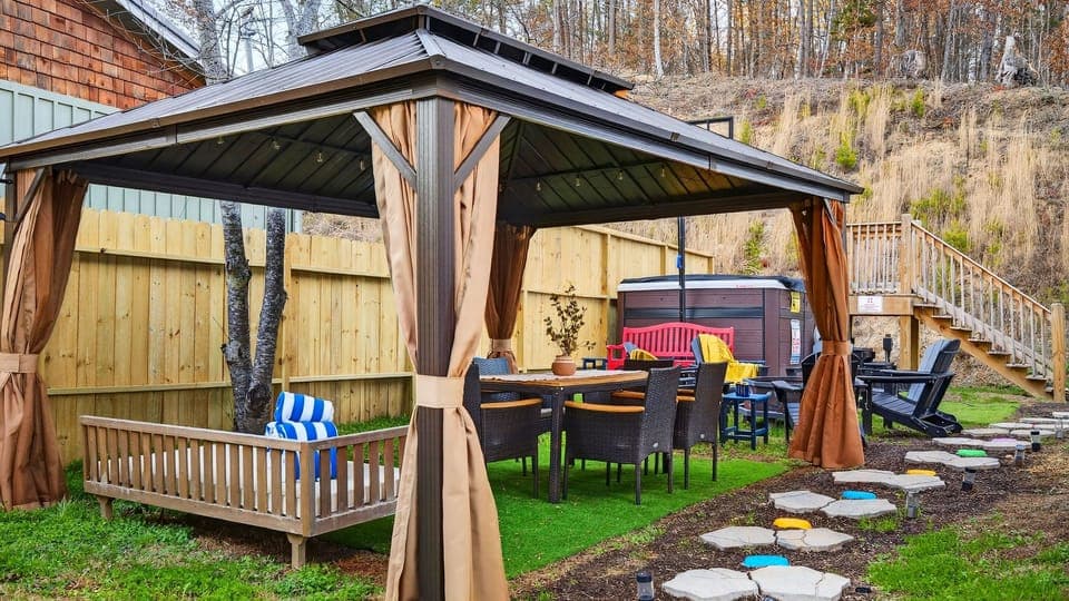 Dine and unwind under the covered gazebo—outdoor seating, string lights, and easy access to the swim spa for laid-back mountain gatherings.