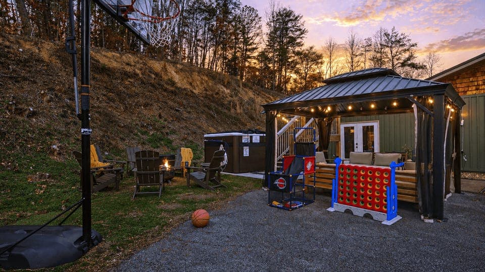 The outdoor hangout brings everyone together, featuring a swim spa, covered lounge pavilion, firepit seating, and games for all ages.