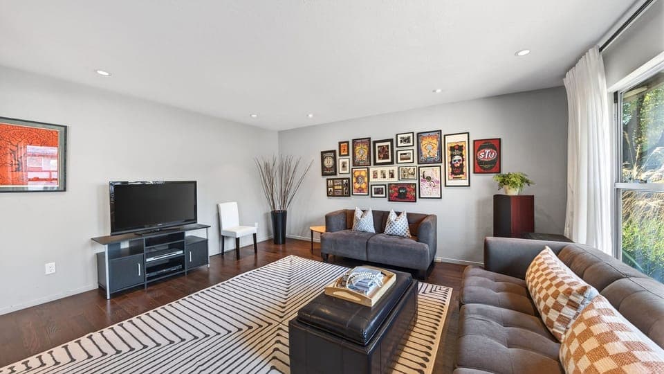 Comfortable living room with curated artwork—an inviting spot to unwind after a day of exploring.