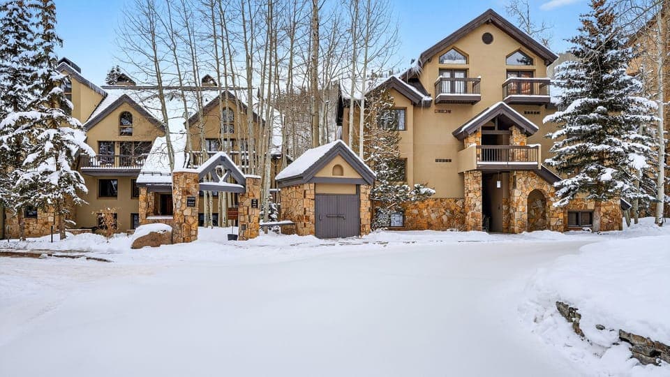 Private covered balcony with peaceful winter views—perfect for morning coffee or après-ski downtime.