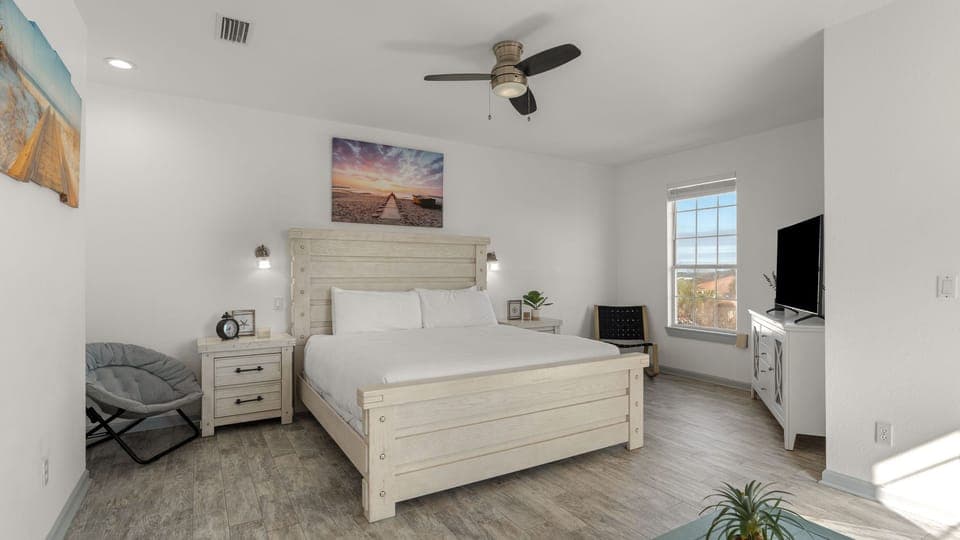 The primary bedroom features a king bed, TV, and an ensuite bathroom.