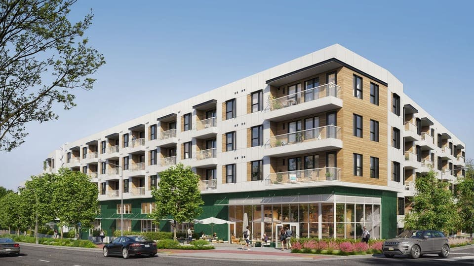 Wide exterior shot of The Code building with modern balconies.