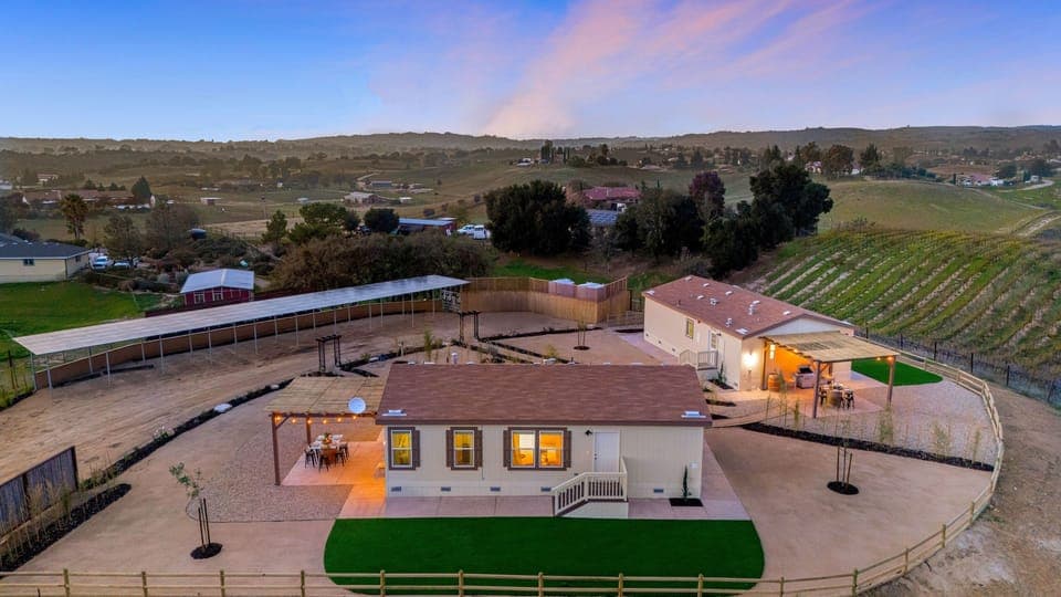 Sweeping vineyard views surround this private two-home Paso Robles retreat.