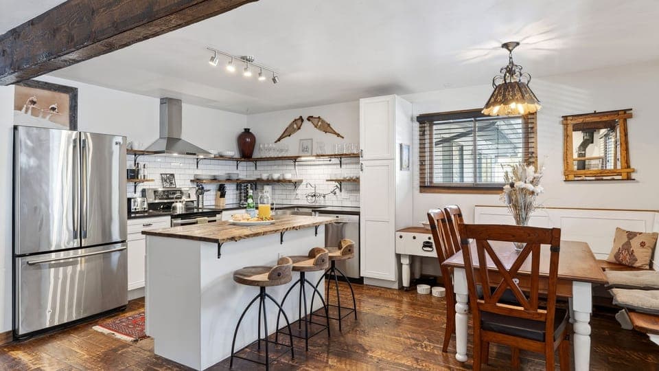 Rustic-chic kitchen and dining area with a breakfast bar—made for easy mornings and cozy meals after a day on the mountain.