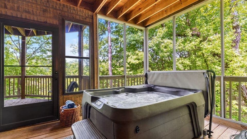 Relax year-round in the private screened-in hot tub, surrounded by peaceful forest views.