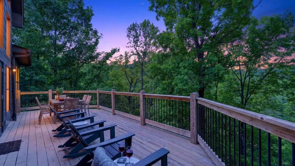 Unwind on the expansive deck with sunset views, cozy lounge seating, and peaceful treetop surroundings.