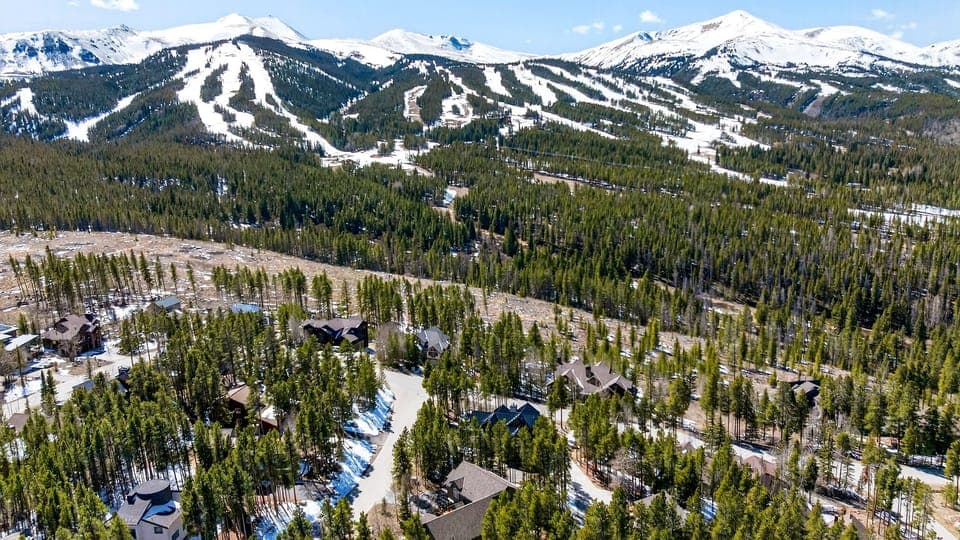 Aerial shot showing the cabin's proximity to the snowy ski runs.
