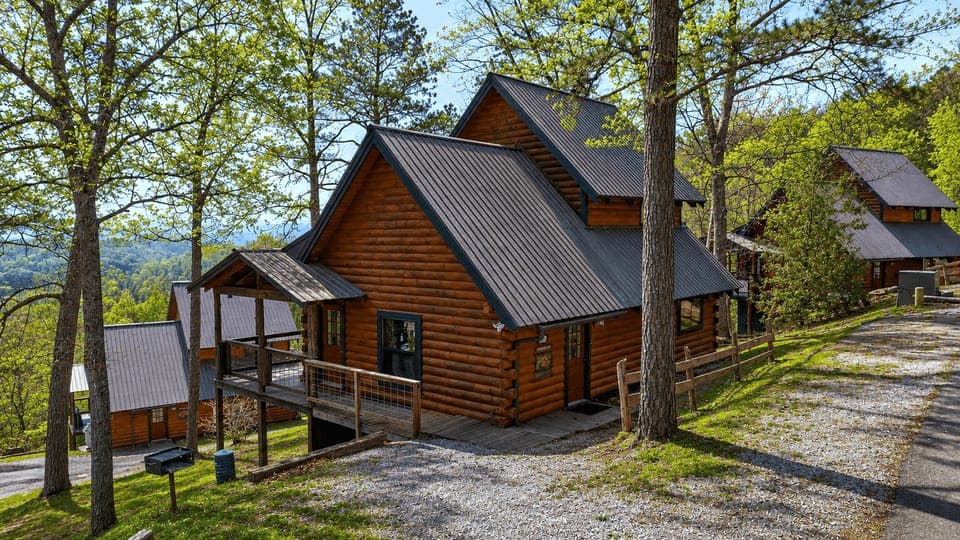 Hillside log cabins tucked among the trees, offering a quiet mountain escape with sweeping valley views.