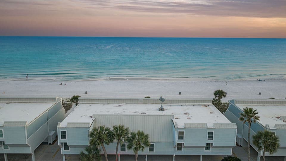 Aerial view of the building directly on the Gulf of Mexico.