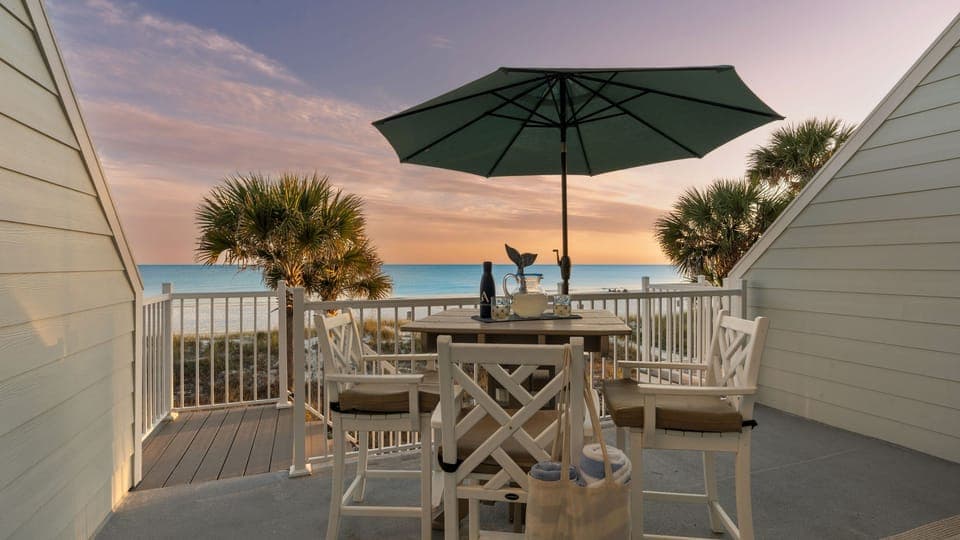 Outdoor dining table with an umbrella for sunset cocktails.