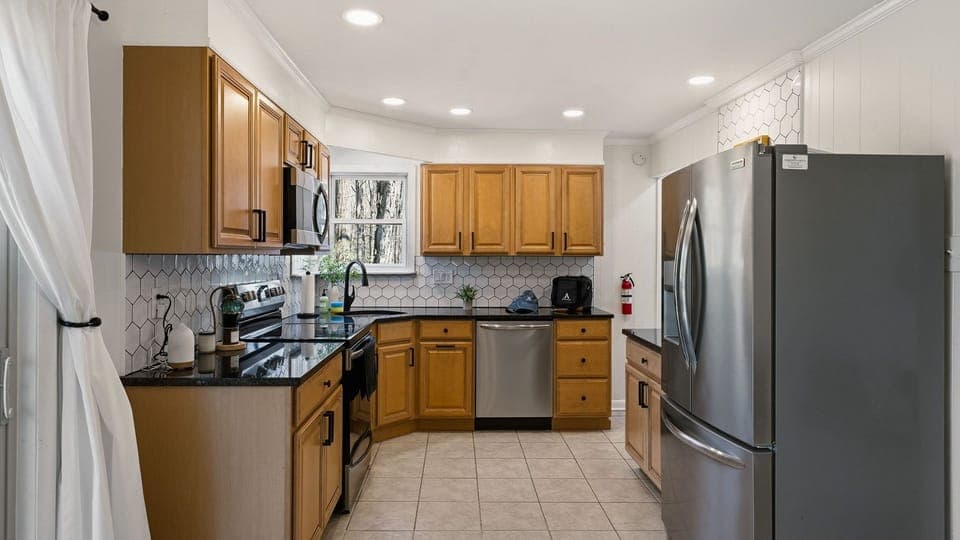 Fully equipped kitchen with stainless steel appliances and ample cabinetry.