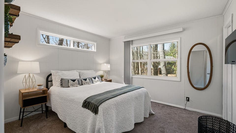 Primary bedroom featuring a queen bed and minimalist, modern decor.