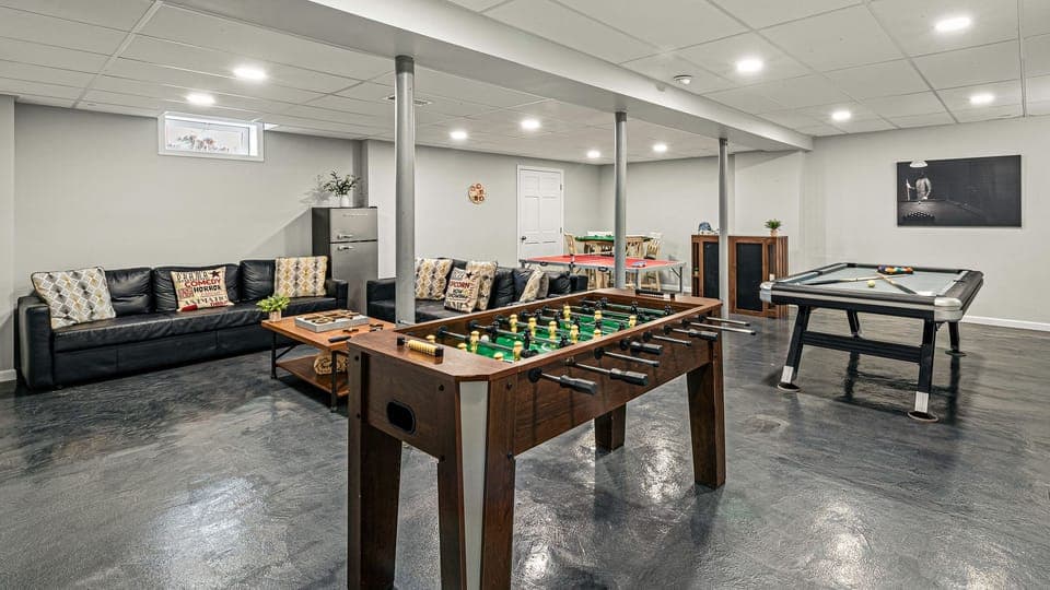 Fun basement rec room with foosball, pool, and a cozy lounge setup for games and laid‑back hangouts. (Laker's Pointe)